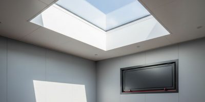A modified shipping container with installed container roof hatches and skylights providing natural light and ventilation, br